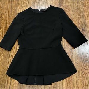 alice + olivia black peplum blouse, short sleeve. Longer back. Hidden zip. Sz M